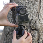 Brinno TLC2020-M time lapse camera placed in green leaves for outdoor use, with waterproof Housing